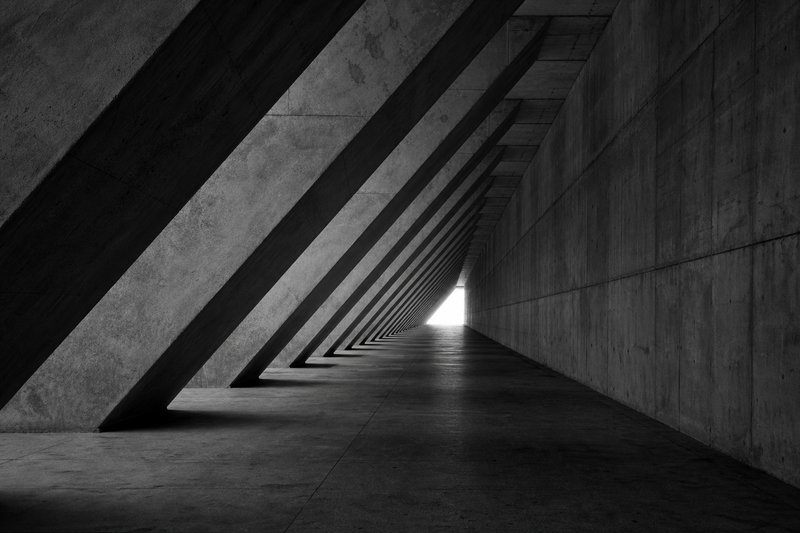Concrete corridor with dramatic geometric perspective